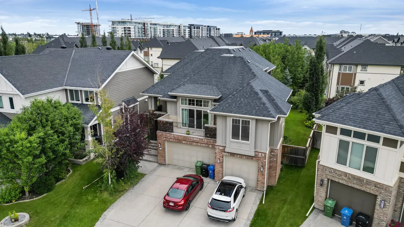A low aerial of 22 Wendham Place from above the cul-de-sac — the full footprint of the home, its driveway, and the neighbouring rooflines of West Springs.