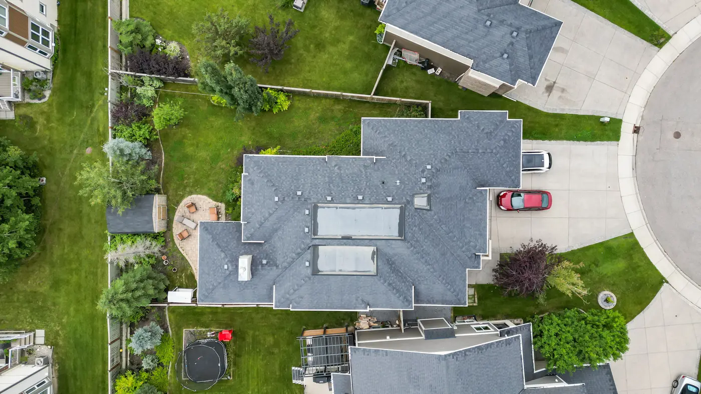 Straight down over the roof — the pie-shaped lot widening behind the house, framed by the curve of the cul-de-sac.