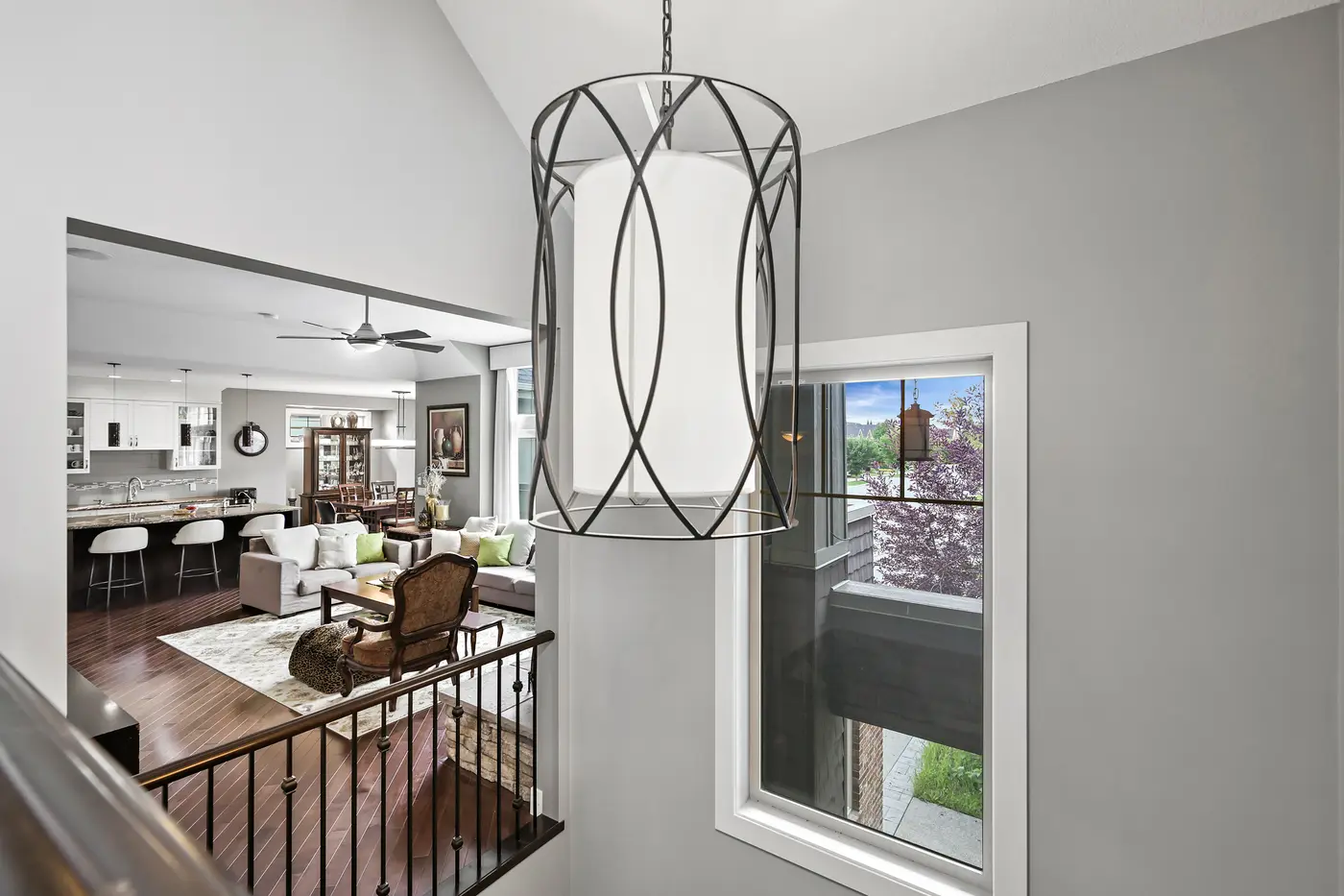 From the upper landing, the pendant light hangs into the double-height space over the kitchen and great room.