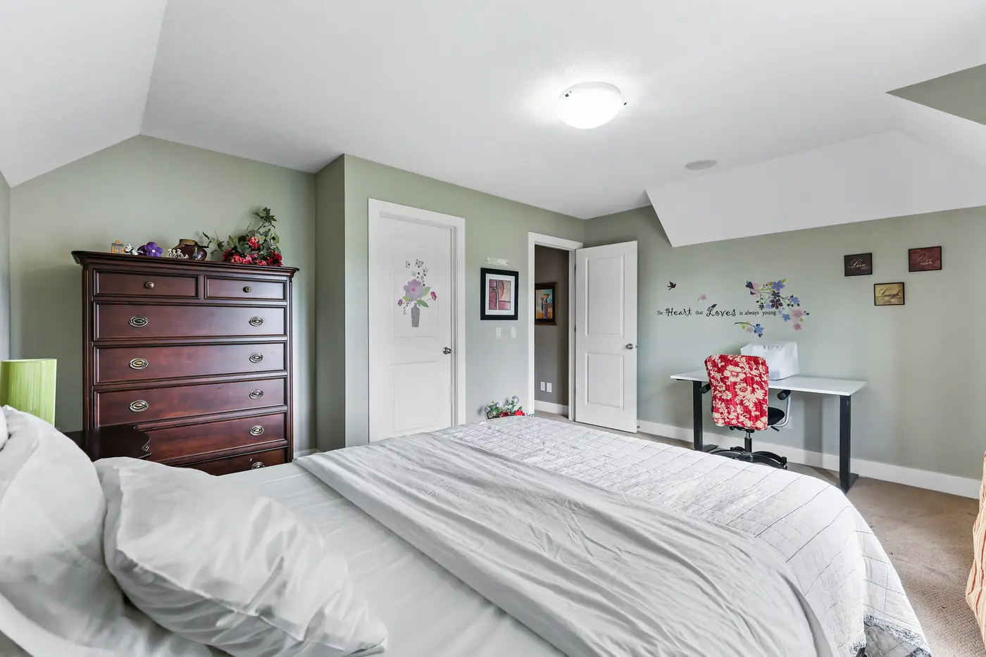 The same upstairs bedroom from the door — dresser, desk nook under the dormer, and room to grow.