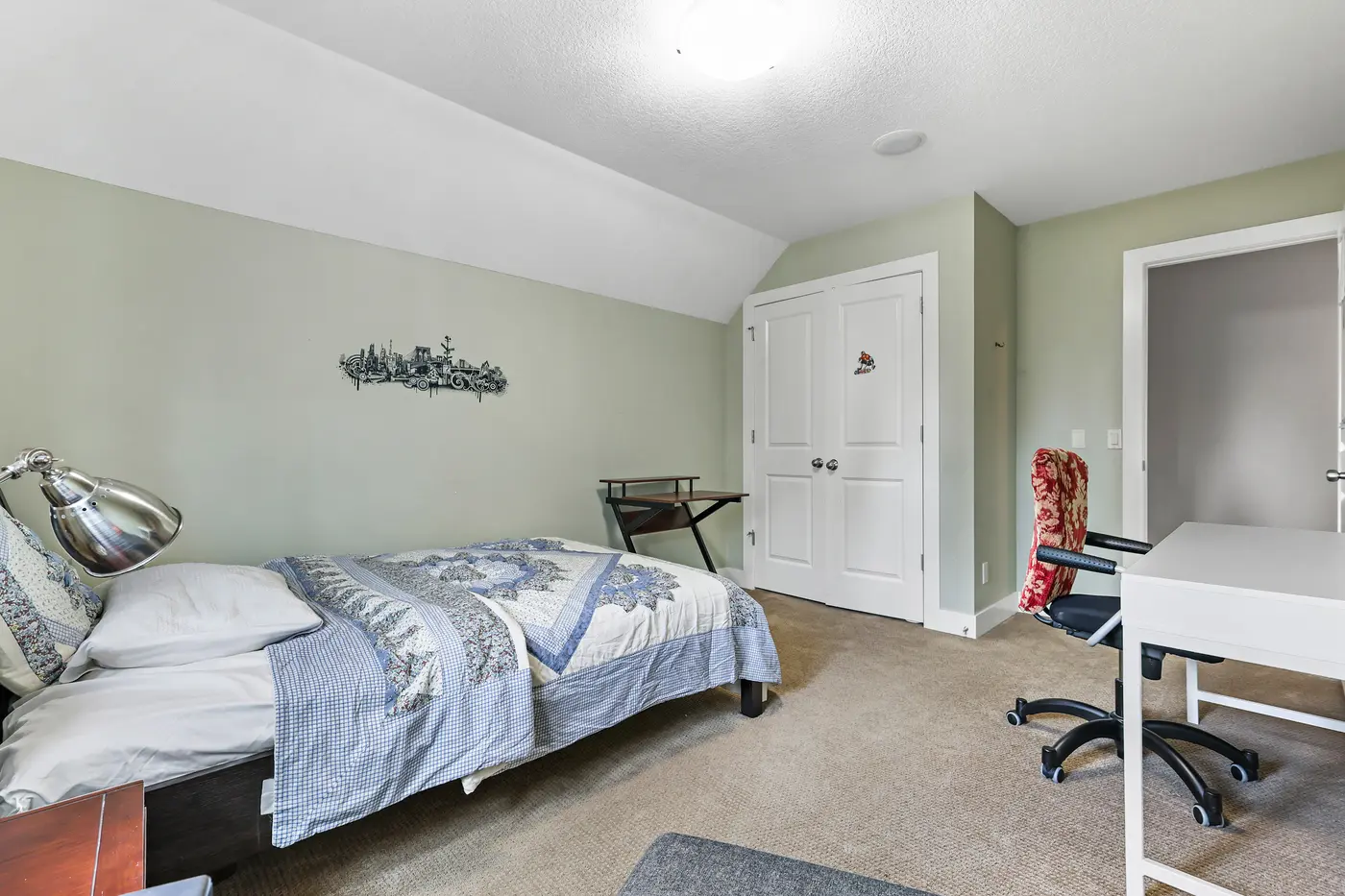 The second upstairs bedroom showing its double closet and work desk.