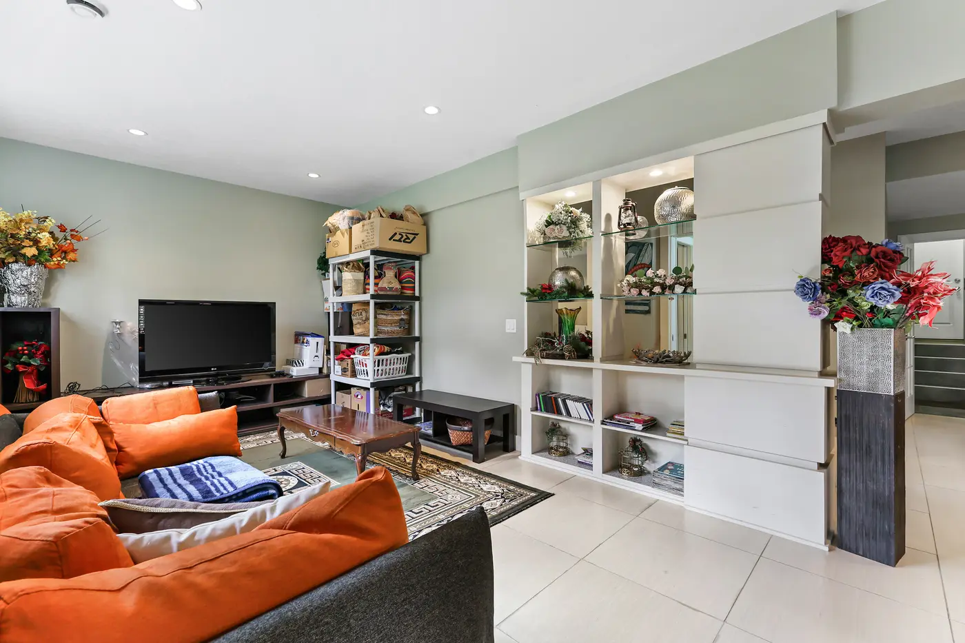 The family room’s built-in display shelving and media wall on the walkout level.